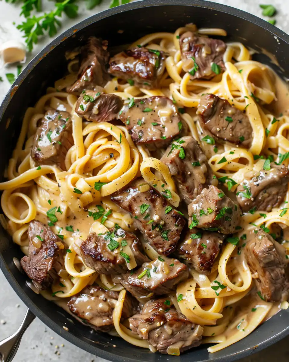 Close-up of ingredients for creamy spicy garlic butter steak pasta including fresh herbs and spices