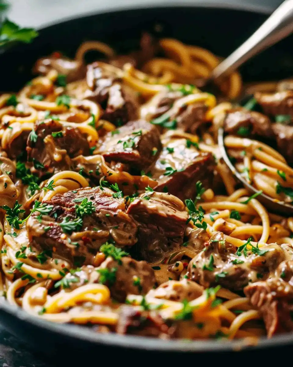 Final plated creamy spicy garlic butter steak pasta served hot