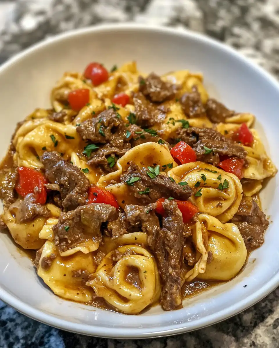 Cooking steps of Philly cheesesteak tortellini in a pot