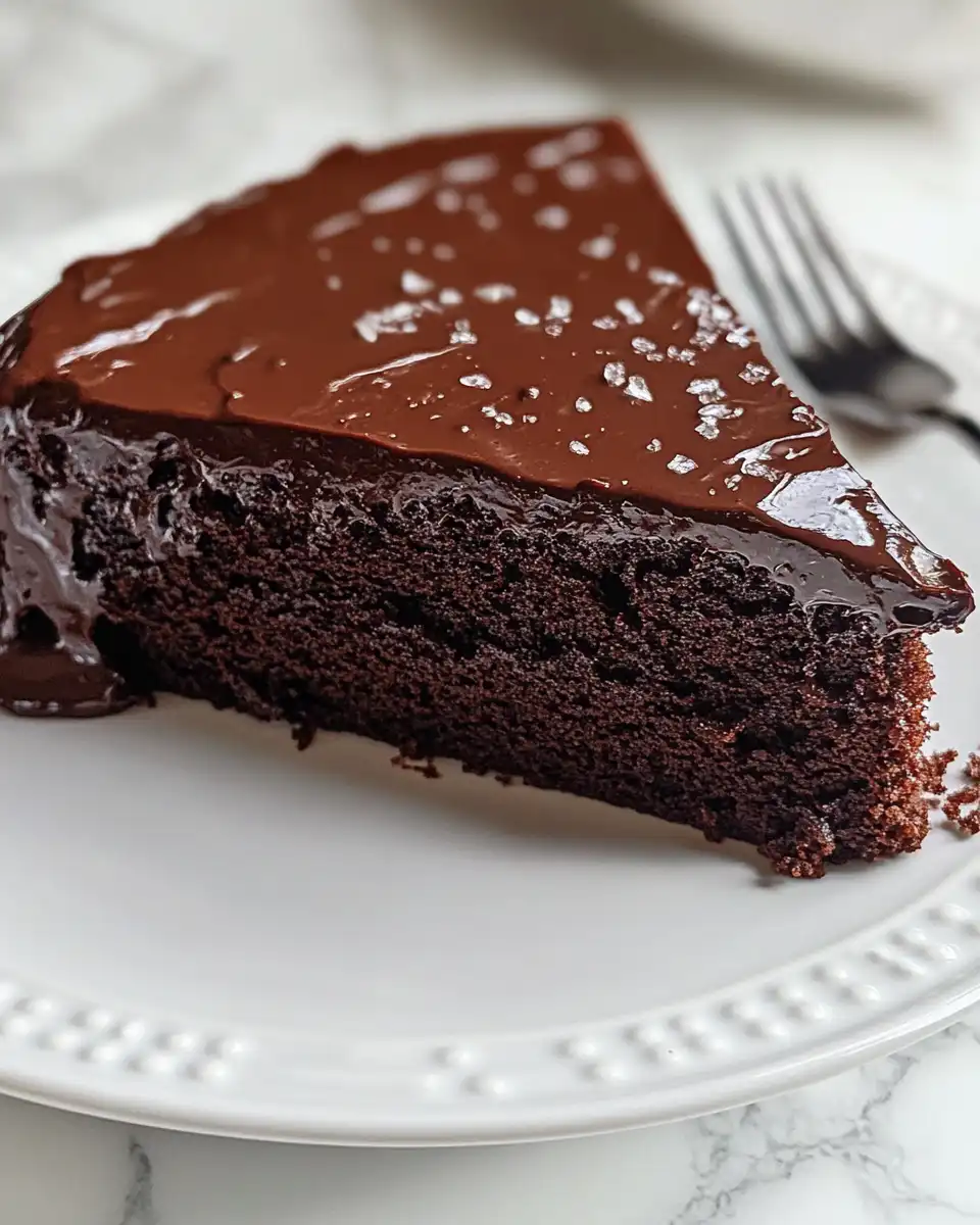 Close up of final frosted chocolate cake slice with chocolate chips
