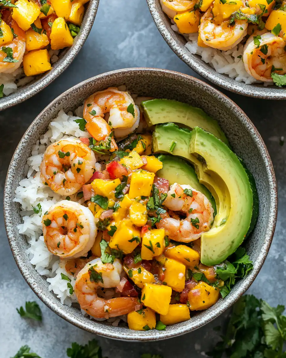 Ingredients for shrimp avocado bowls with mango salsa including shrimp and fresh mango