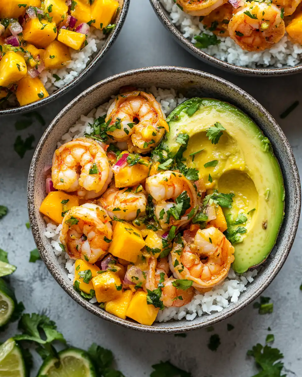 Finished shrimp avocado bowls topped with mango salsa and cilantro
