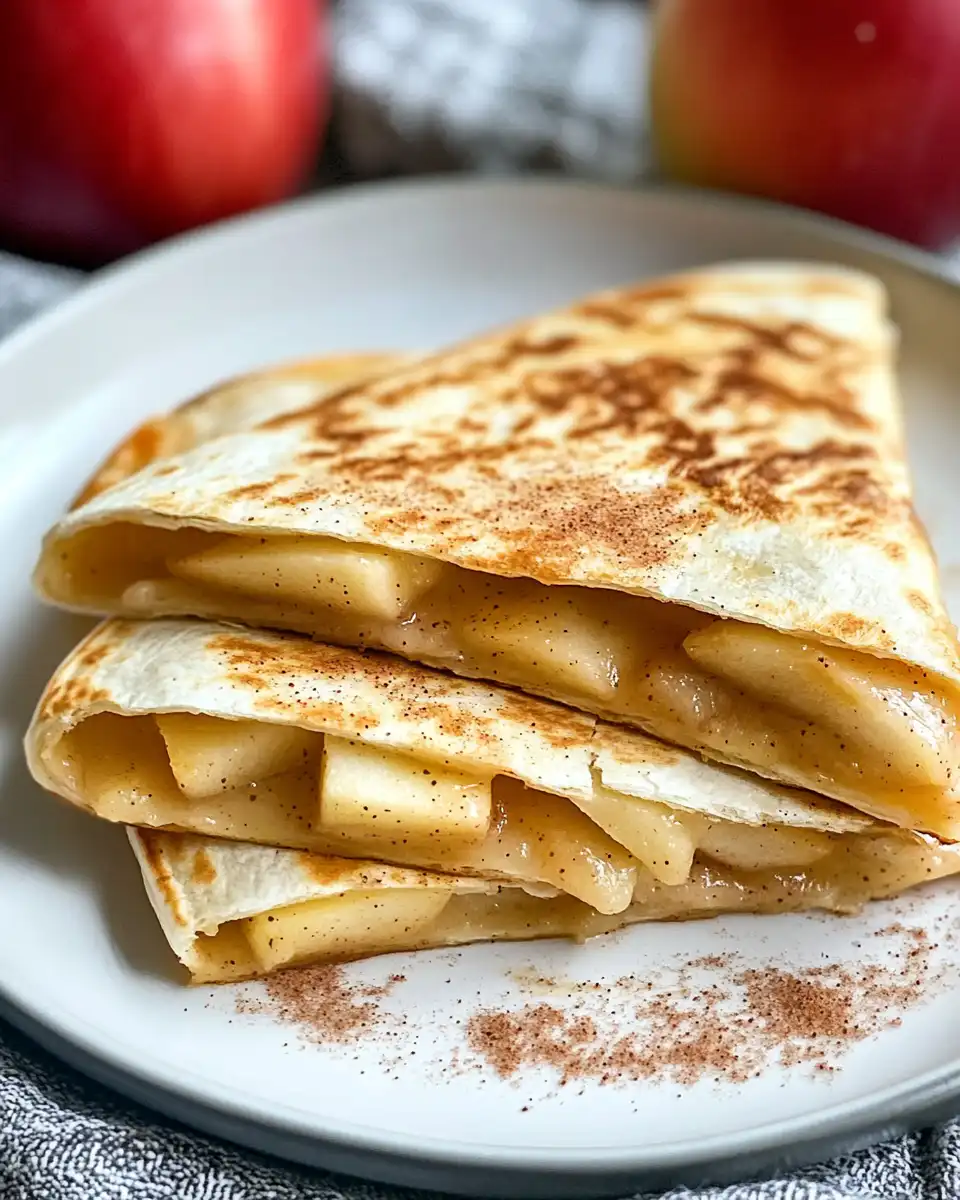 Sliced apple cinnamon cheddar quesadillas on a plate ready to serve